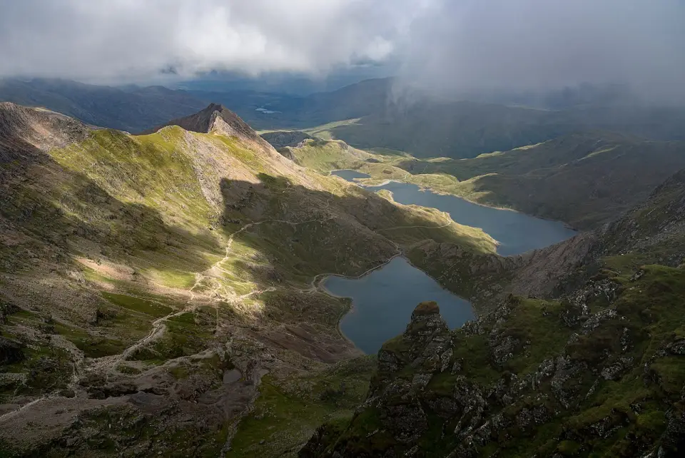 Glaslyn and Llyn Llydaw below Yr Wyddfa, with the Pyg Track and Miners' Track climbing the slope on the left under low cloud
